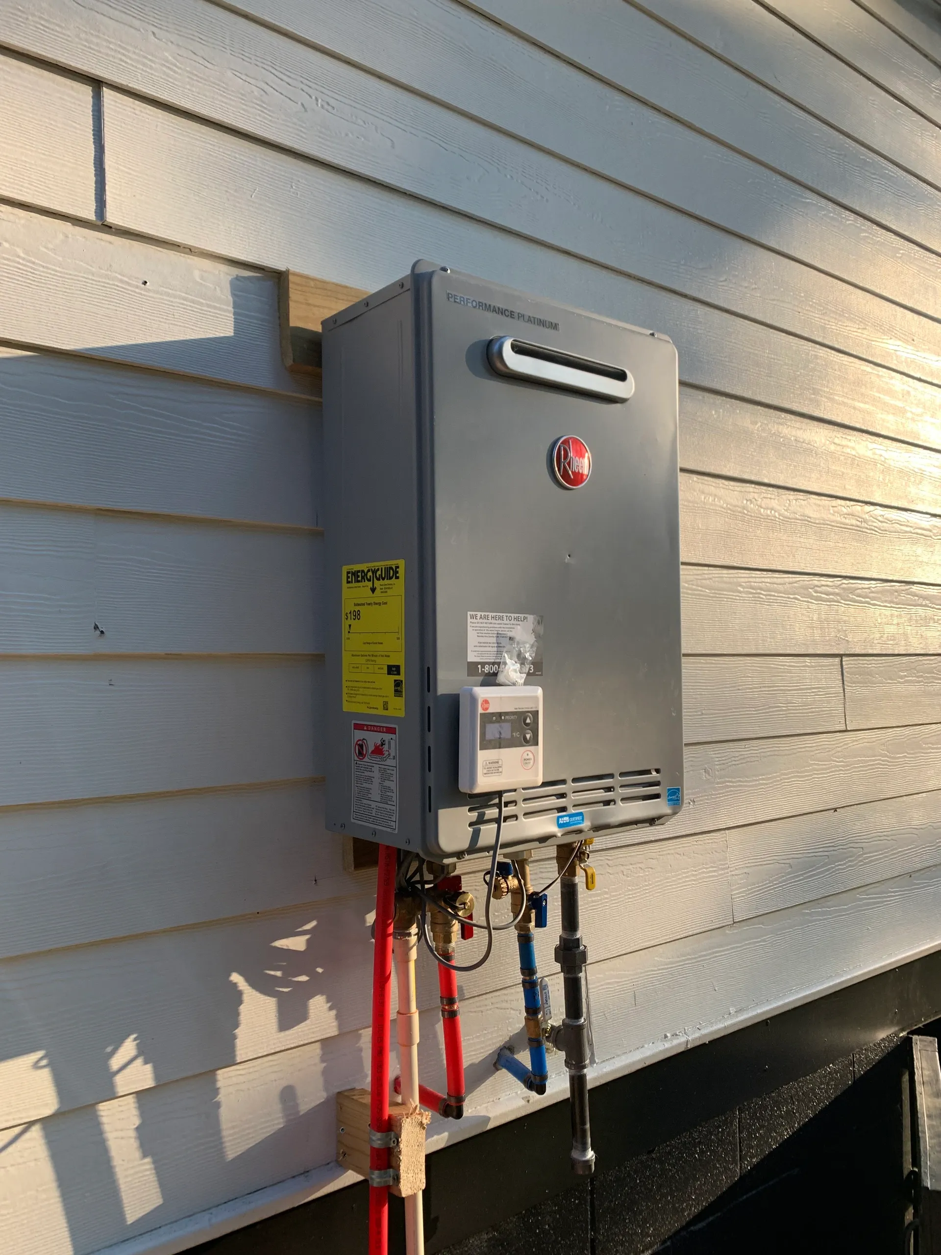 Outdoor tankless water heater installed by RDP Plumbing on an Atlanta home