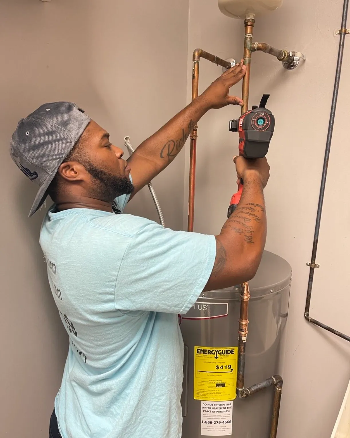 Plumber installing a new water heater in an Alpharetta, GA home